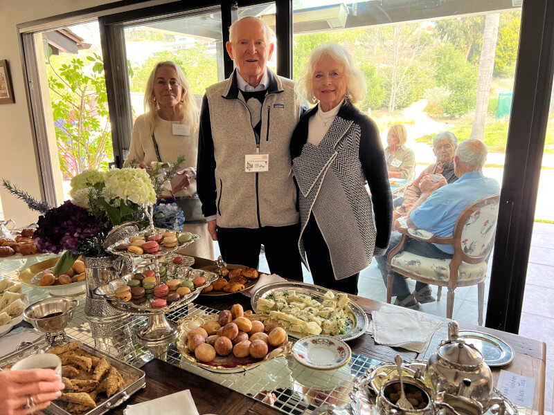 Glen and Terry standing at the table of delectables