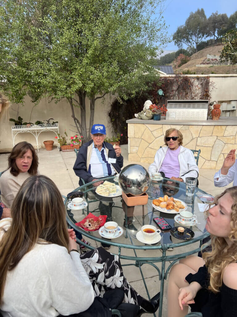 Guests sitting outside at a round glass top table